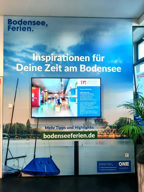 Tourist visitor information center screen at Lake Constance showing interactive maps, ferry schedules, and regional attraction recommendations