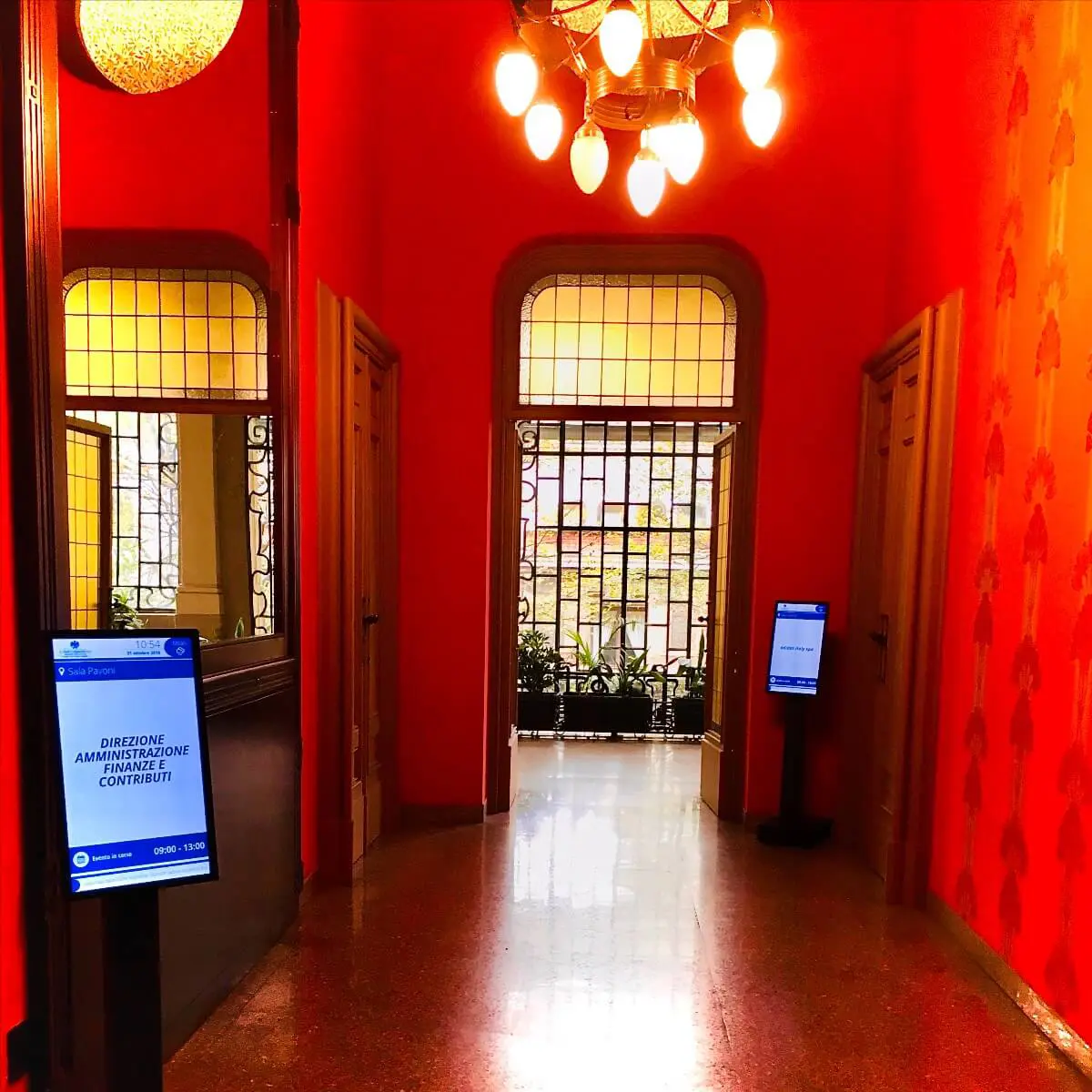 Confcommercio Milano office screens displaying corporate communications, industry news, and economic data powered by SpinetiX media players