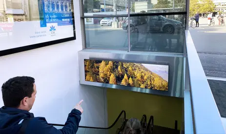 Parking Riponne underground car park in Lausanne with SpinetiX digital signage displays showing available spaces, navigation arrows, and event alerts