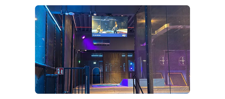 Activity zones at Space Magic entertainment center with SpinetiX digital displays showing safety instructions, wait times, and attraction information